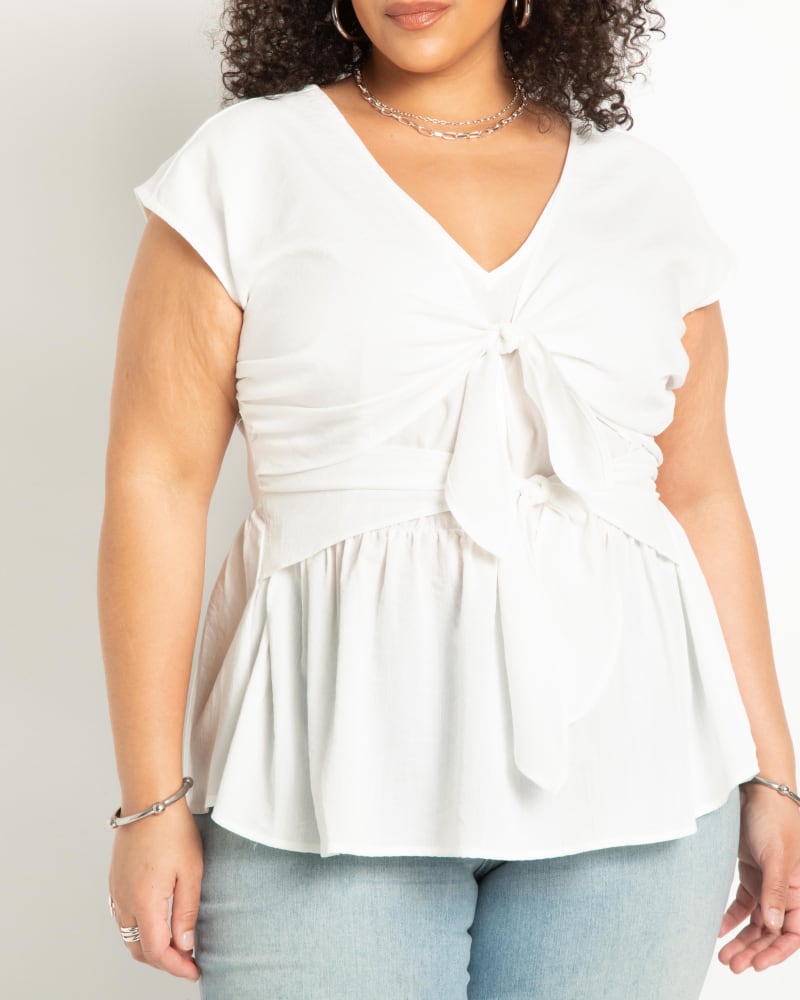 Front of a model wearing a size 16 Bow Detail Peplum Blouse in True White by ELOQUII. | dia_product_style_image_id:284418